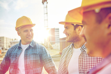 Wall Mural - group of smiling builders in hardhats outdoors