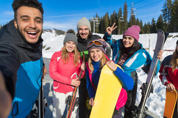 Wall Mural - People Group With Snowboard And Ski Resort Snow Winter Mountain Cheerful Friends Taking Selfie Photo Having Fun