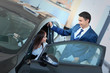 © ASDF - happy woman inside car in auto show or salon