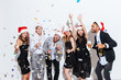 © Drobot Dean - People in santa claus hats drinking champagne and having fun