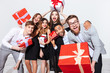 © Drobot Dean - Happy funny young people holding gift boxes and having fun