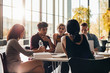 © Jacob Lund - Young students studying around a table in library