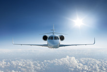 Private Jet Flying Towards The Camera With The Sun In Blue Sky