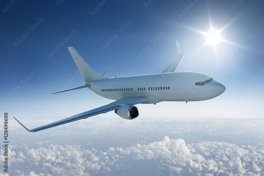 Airliner flying above the clouds with the sun in blue sky - obrazy, fototapety, plakaty 