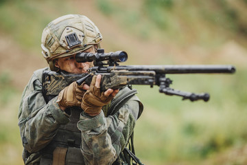 Wall Mural - Portrait of a ranger in the battlefield with a gun