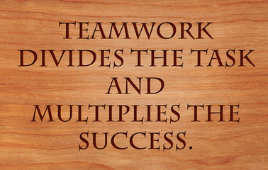 Teamwork divides the task and multiplies the success - quote by unknown author on wooden red oak background
