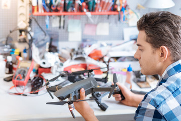 Wall Mural - Young man holding drone propeller and remore controller