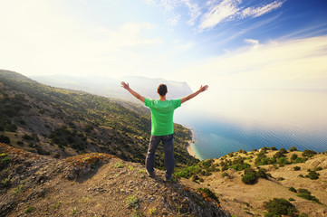 Man on peak of mountain. Emotional scene.