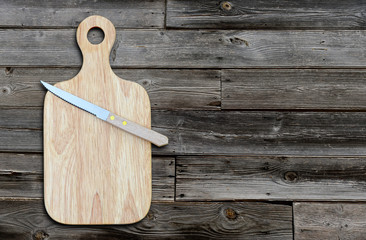 Wall Mural - Empty cutting board and knife on a old wooden table for product display.Top view