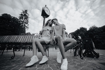 Wall Mural - guy and girl sitting on a bench