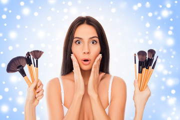 Sticker - Shocked pretty woman  getting many  makeup brushes as new year p