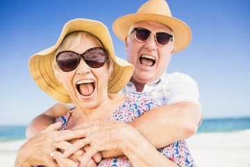 Senior couple with hat embracing