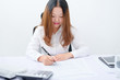 © Weidong - Young businesswoman working at desk.