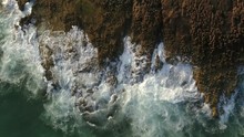 Aerial. Slow Motion Of The Sea On The Rocks, View From The Sky.