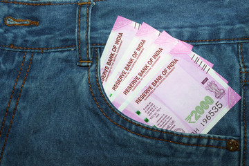 New 2000 rupee notes in an Indian mans jean front pocket.