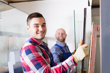 Wall Mural - Two workers working with glass