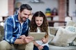 © WavebreakmediaMicro - Father and daughter using digital tablet in living room