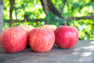 Poster - Ripe red apples on wooden background