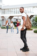© Drobot Dean - Smiling african man student with backpack walking in campus