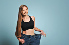 Fit Young Woman In Loose Jeans