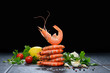 Cooked shrimps,prawns with seasonings on black background