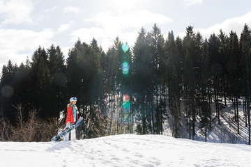 Wall Mural - Woman snowboarder on the slopes frosty winter day