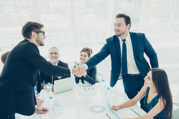 Business people shaking hands successfuly  finishing up a meetin