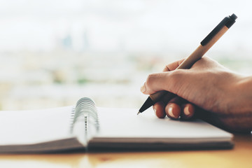 Wall Mural - Girl writing in spiral notepad