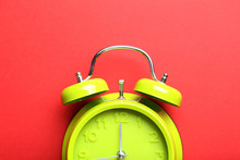 Green Alarm Clock On A Red Background