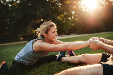 Wall Mural - Young health couple exercising in park