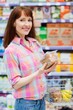 © WavebreakMediaMicro - Smiling woman posing with her shopping basket