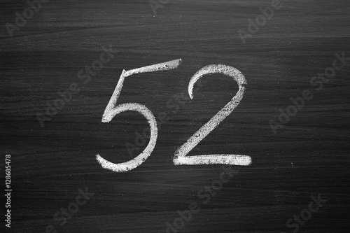 Poster number fifty two enumeration written with a chalk on the blackboard