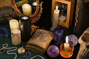 Magic still life with the Tarot cards, mirrow and burning candles