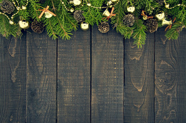 frame from decorated christmas tree on rustic wooden background