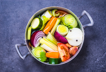 Vegetable stock or broth, vegetable soup top view copy space.