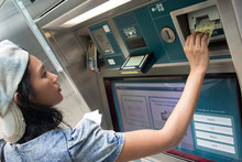 Young Woman Buys A Ticket Vending Machine