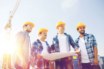 Canvas Print - group of builders with tablet pc and blueprint