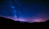 Fototapeta Łazienka - night sky stars milky way blue purple sky in starry night over mountains
