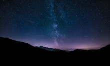 Purple Night Sky Stars. Milky Way Galaxy Across Mountains. Starr