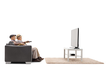 Poster - Two mature men sitting on a sofa and watching television