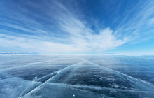 Frozen Lake Baikal. Beautiful Stratus Clouds Over The Ice Surface On A Frosty Day. Natural Background
