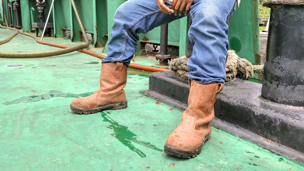 looked shoes and jeans of a worker