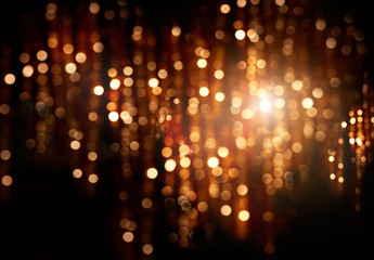 Wall Mural - christmas holiday glowing backdrop. defocused golden background with blinking stars