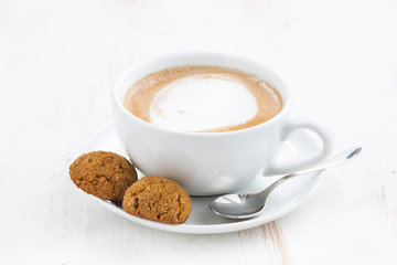 Wall Mural - cup of cappuccino and flavored cookies, selective focus