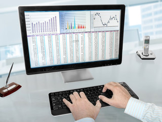 Fototapete - Male Hands on the Keyboard in Front of Computer Screen with Financial Data and Charts