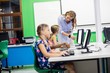 © WavebreakmediaMicro - Teacher giving lesson to her students with technology
