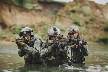 Wall Mural - Military team crossing the river under fire