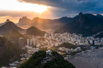Wall Mural - Sun is shining through the clouds on the Rio de Janeiro city, View from the Sugarloaf Mountain