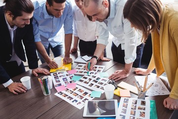 High angle view of of photo editors looking at photos