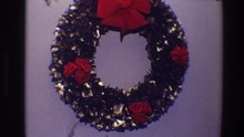1968: Christmas Wreath Made From Metallic Loops Is Decorated With Rosettes And A Bow TOLEDO OHIO